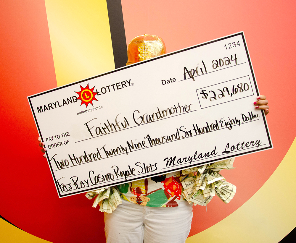 “Faithful Grandmother,” a longtime Maryland Lottery player from Annapolis, shows off her winnings from an April 22 progressive jackpot win on the FAST PLAY game Casino Royale Slots.