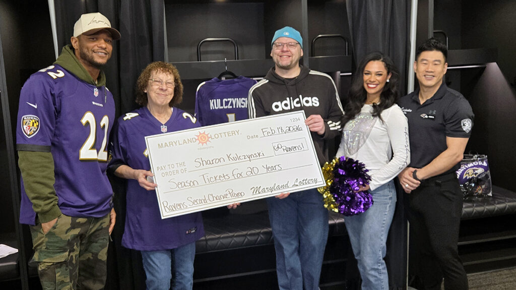 Sharon Kulczynski is all smiles after she won the Ravens “Seats For 20 Years” prize.