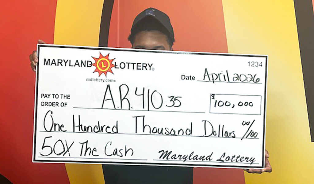Baltimore resident “A.R.” celebrates April 24 at Lottery headquarters after claiming a $100,000 top prize on the 50X the Cash scratch-off.
